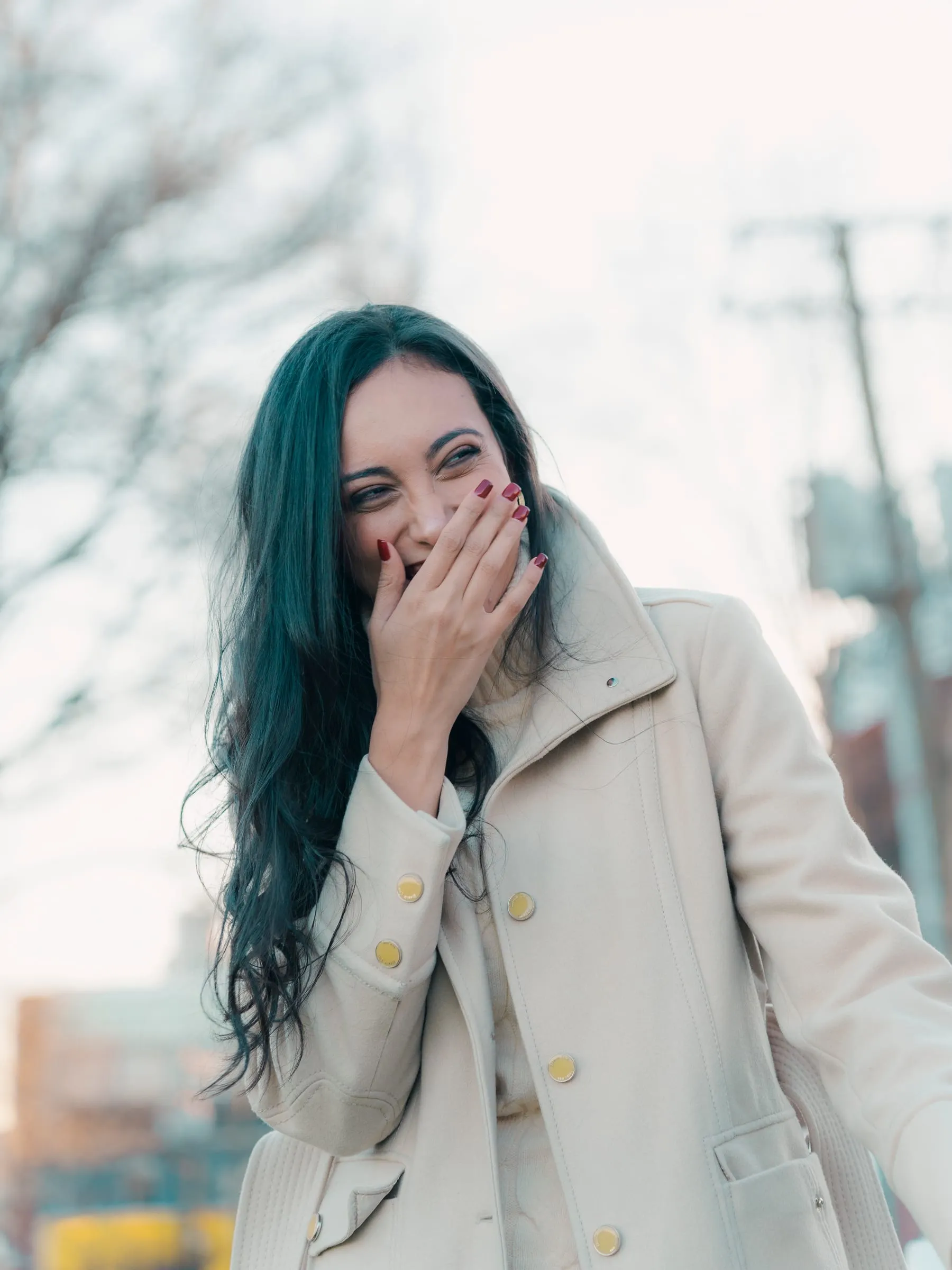 Close-up of Merona laughing behind one hand as the proposal begins
