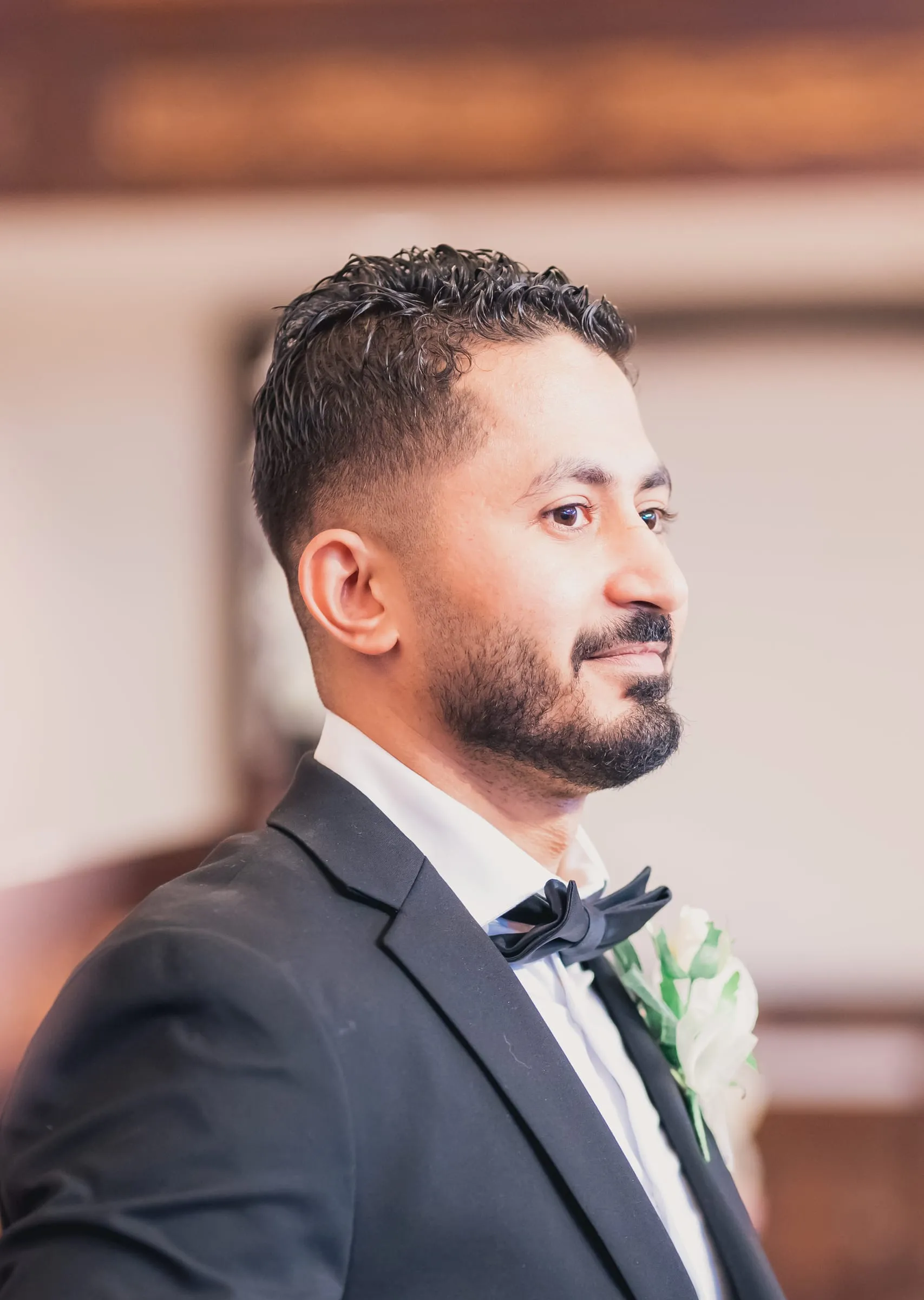 Fady waiting at the altar in a black tuxedo and bow tie at St. Mark Coptic Orthodox Church