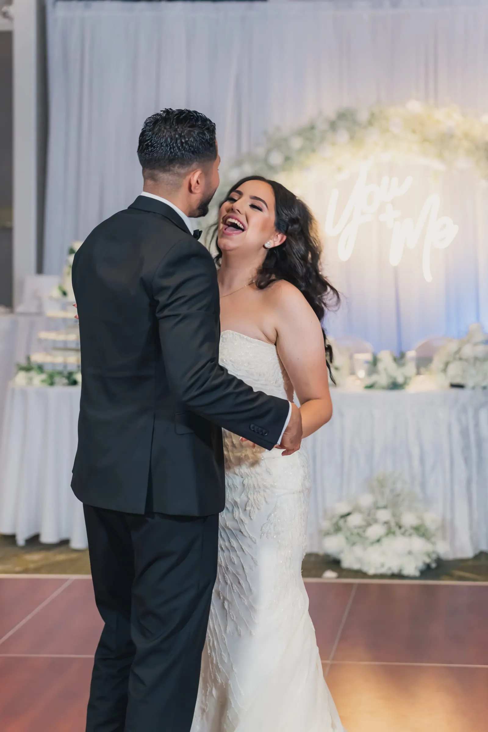 Gina laughing, head thrown back, as Fady holds Gina close on the dance floor