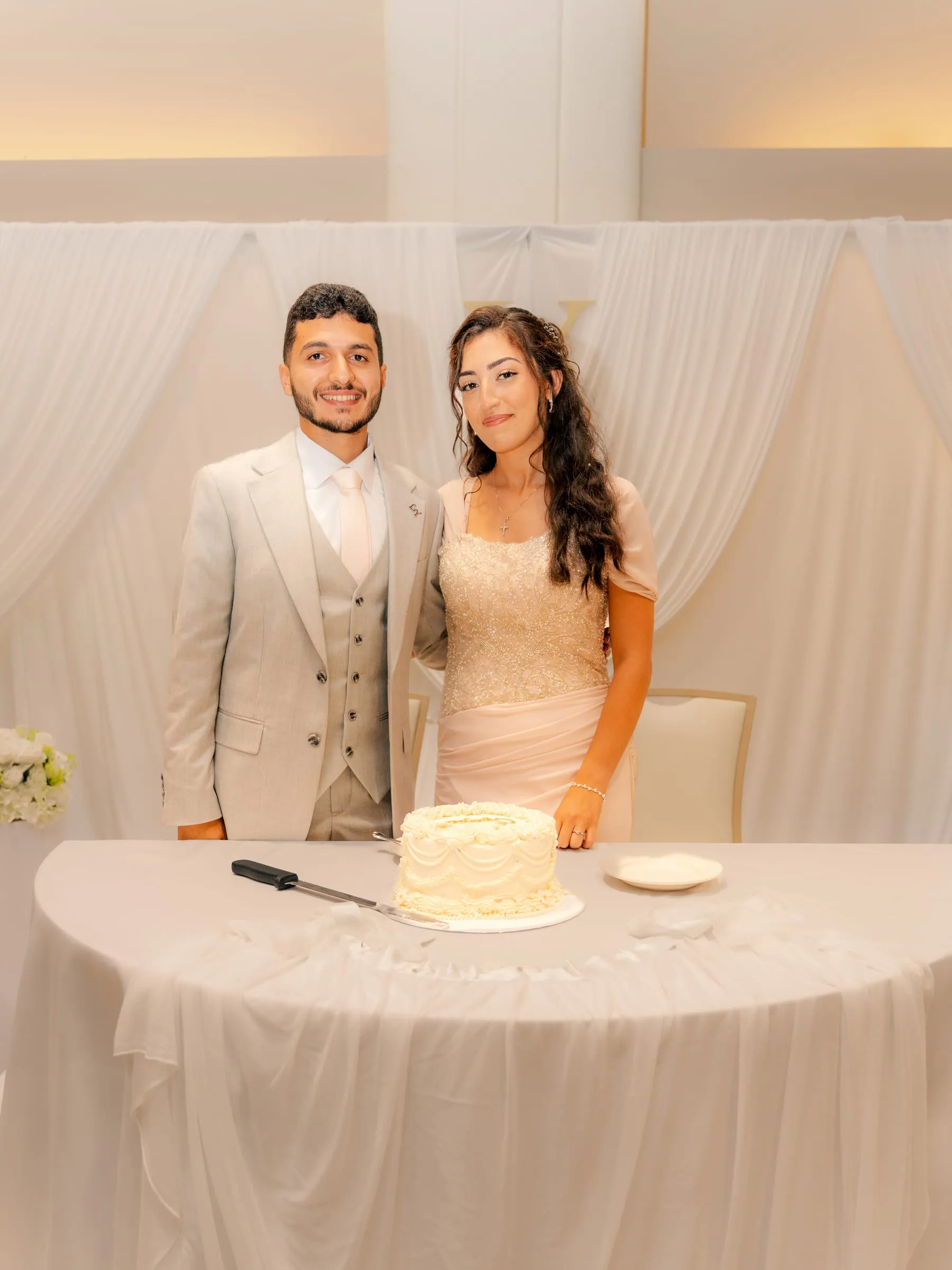 Lavina and Youssef standing close together at their engagement celebration