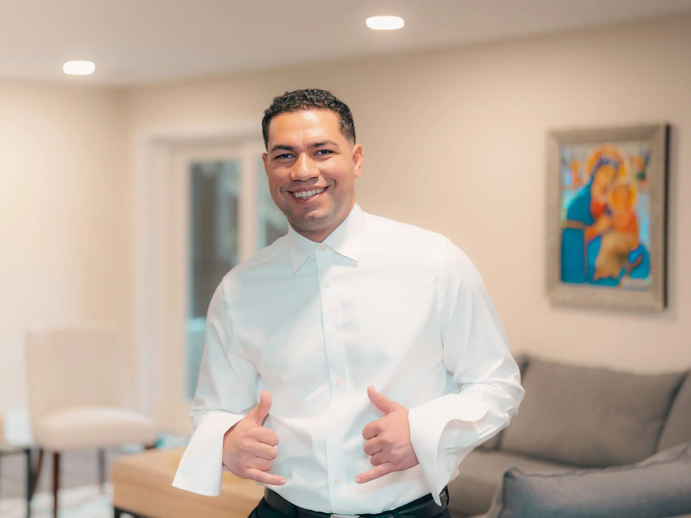 A groomsman giving a thumbs-up while getting ready for Mariam and Mina's wedding