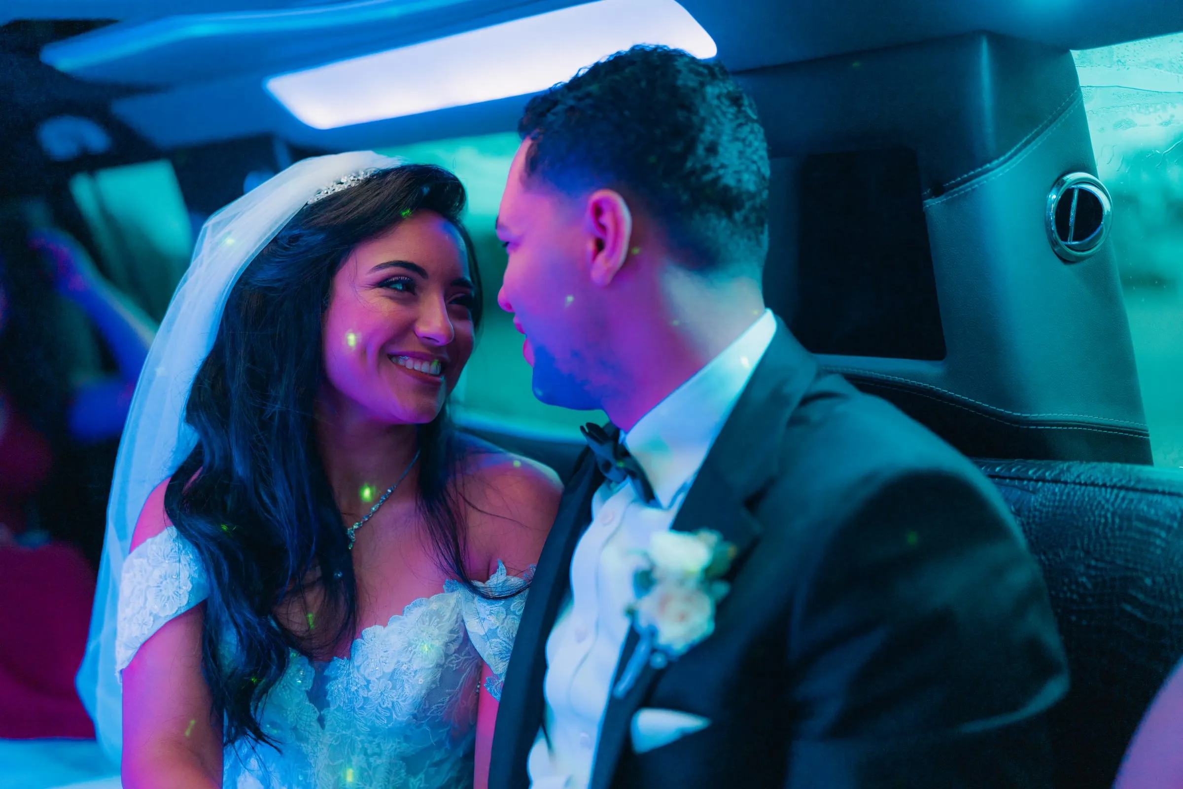 Mariam and Mina smiling at each other inside the limo