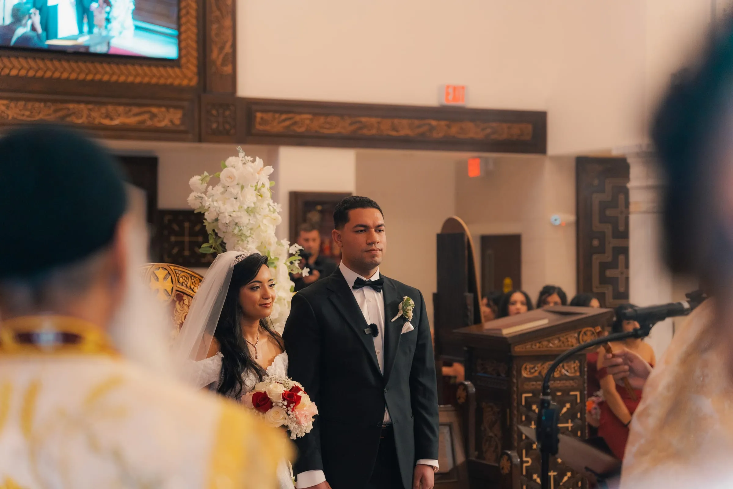 Mariam and Mina standing together at the altar during their wedding ceremony