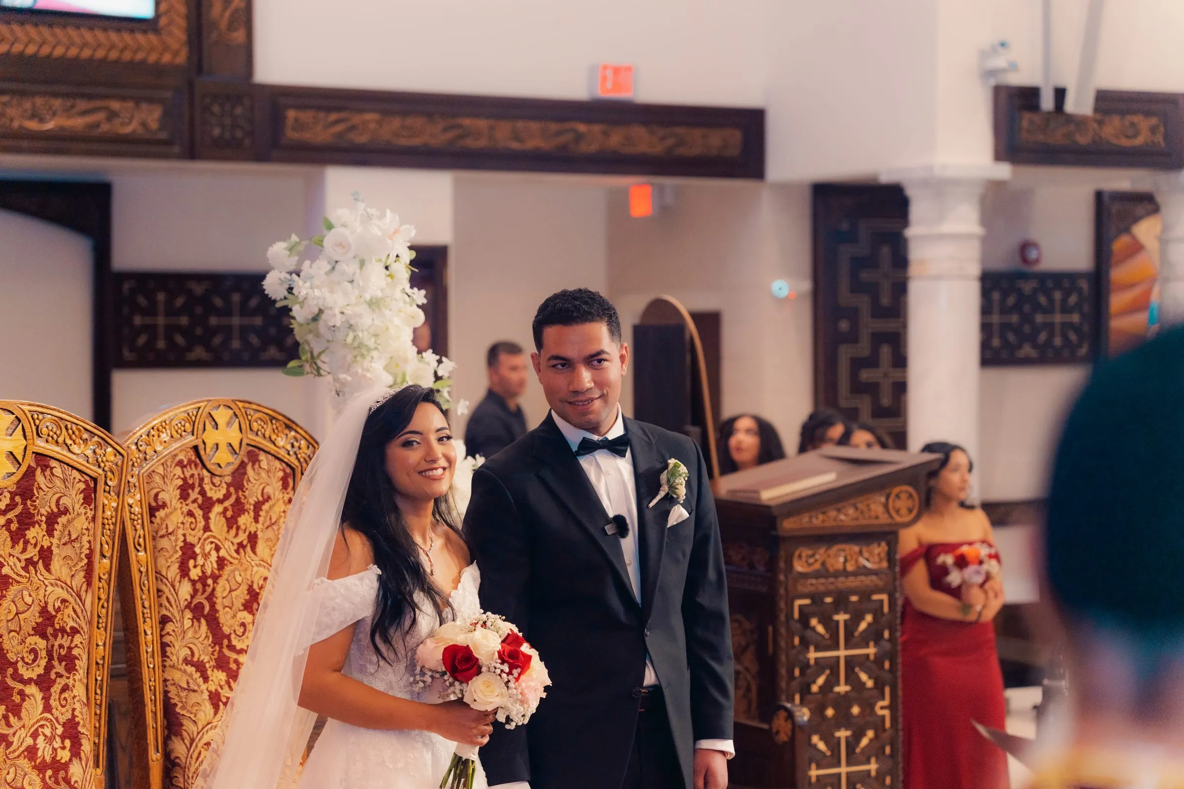 Mariam smiling at the altar beside Mina during the Coptic wedding service