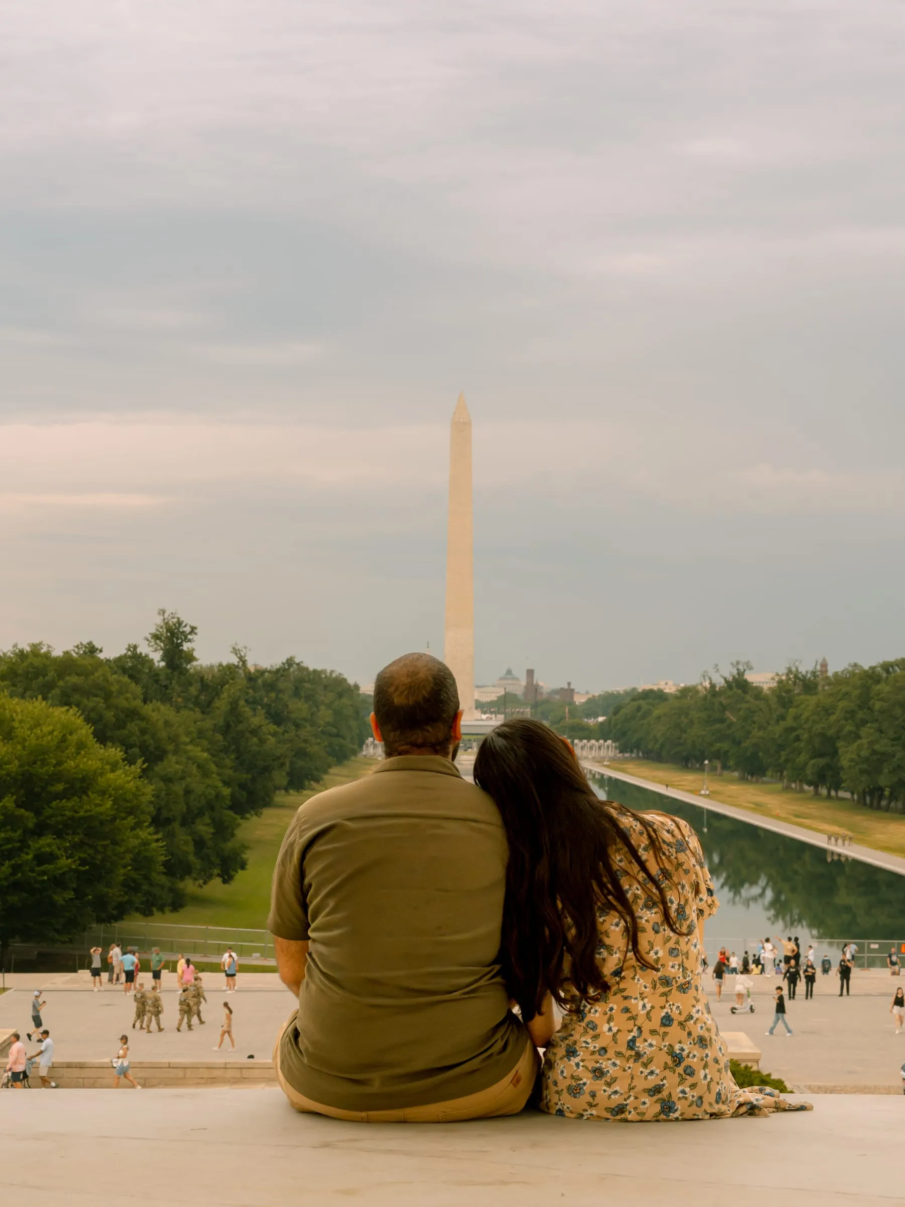 Maryann and Samuel seated together looking down the National Mall toward the Washington Monument