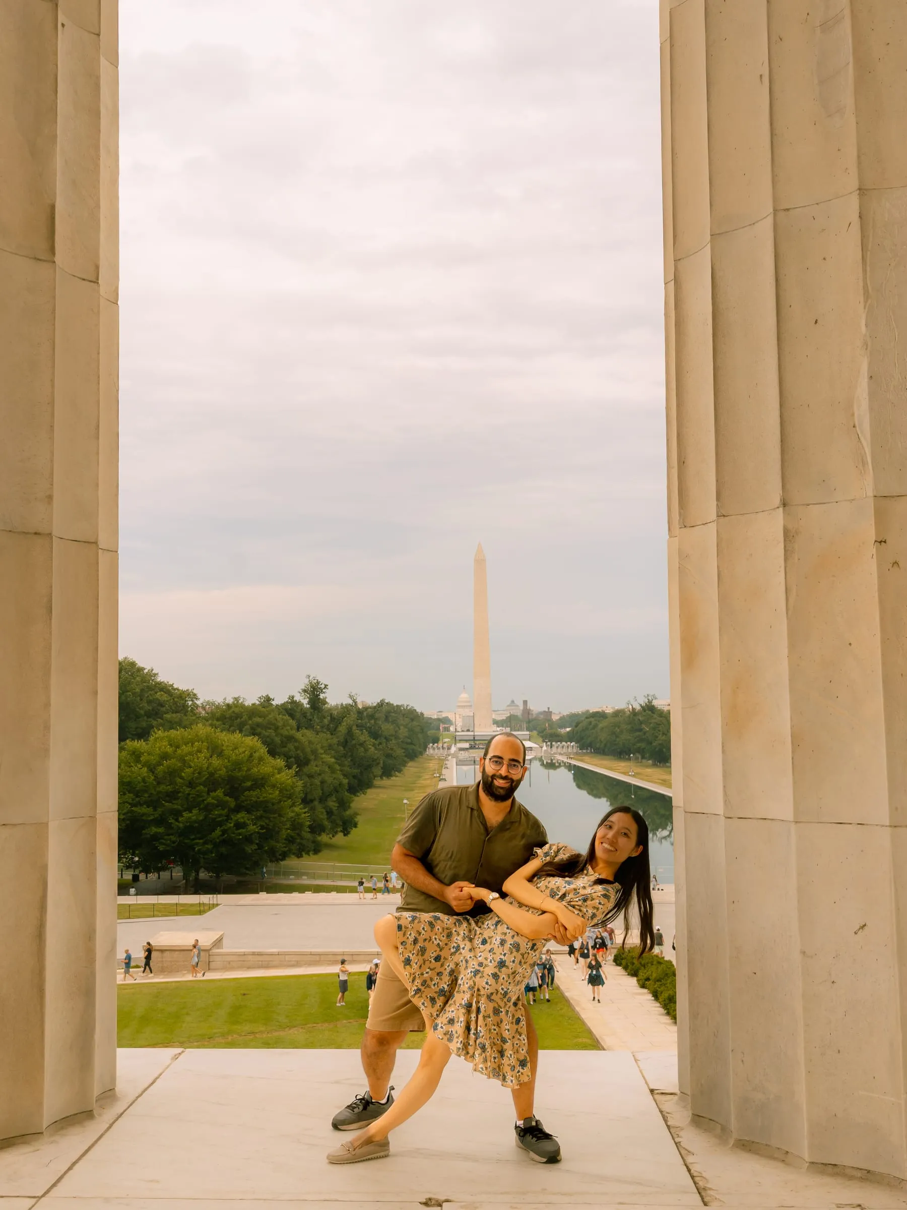 Maryann and Samuel mid-dance move between the columns, the National Mall stretching out behind them