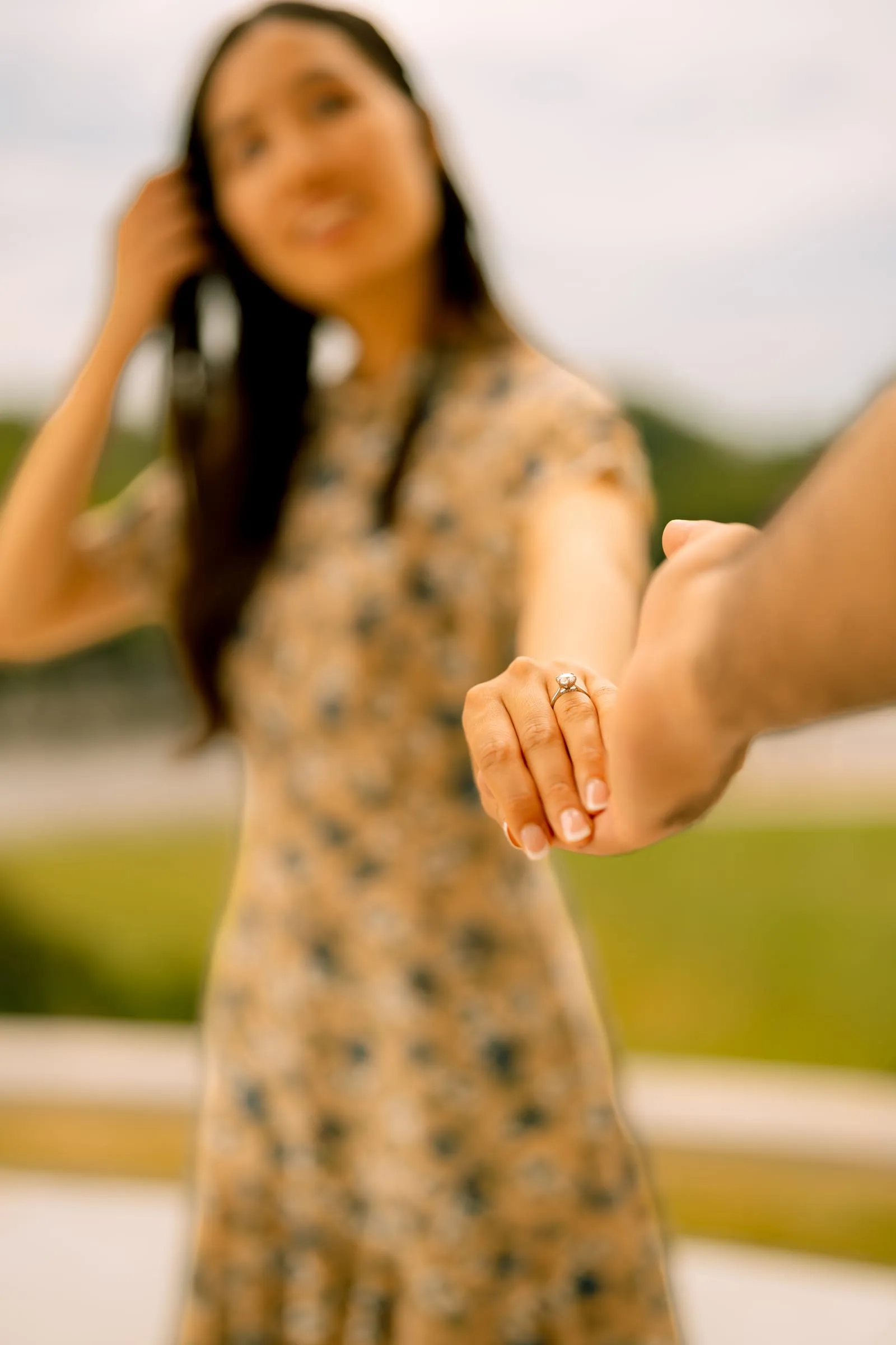 Close-up of Maryann's engagement ring as she reaches toward Samuel