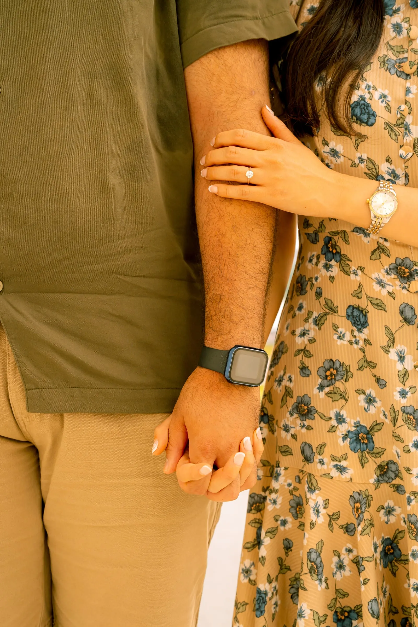 Close-up of Maryann's hand on Samuel's arm, her ring and his watch visible