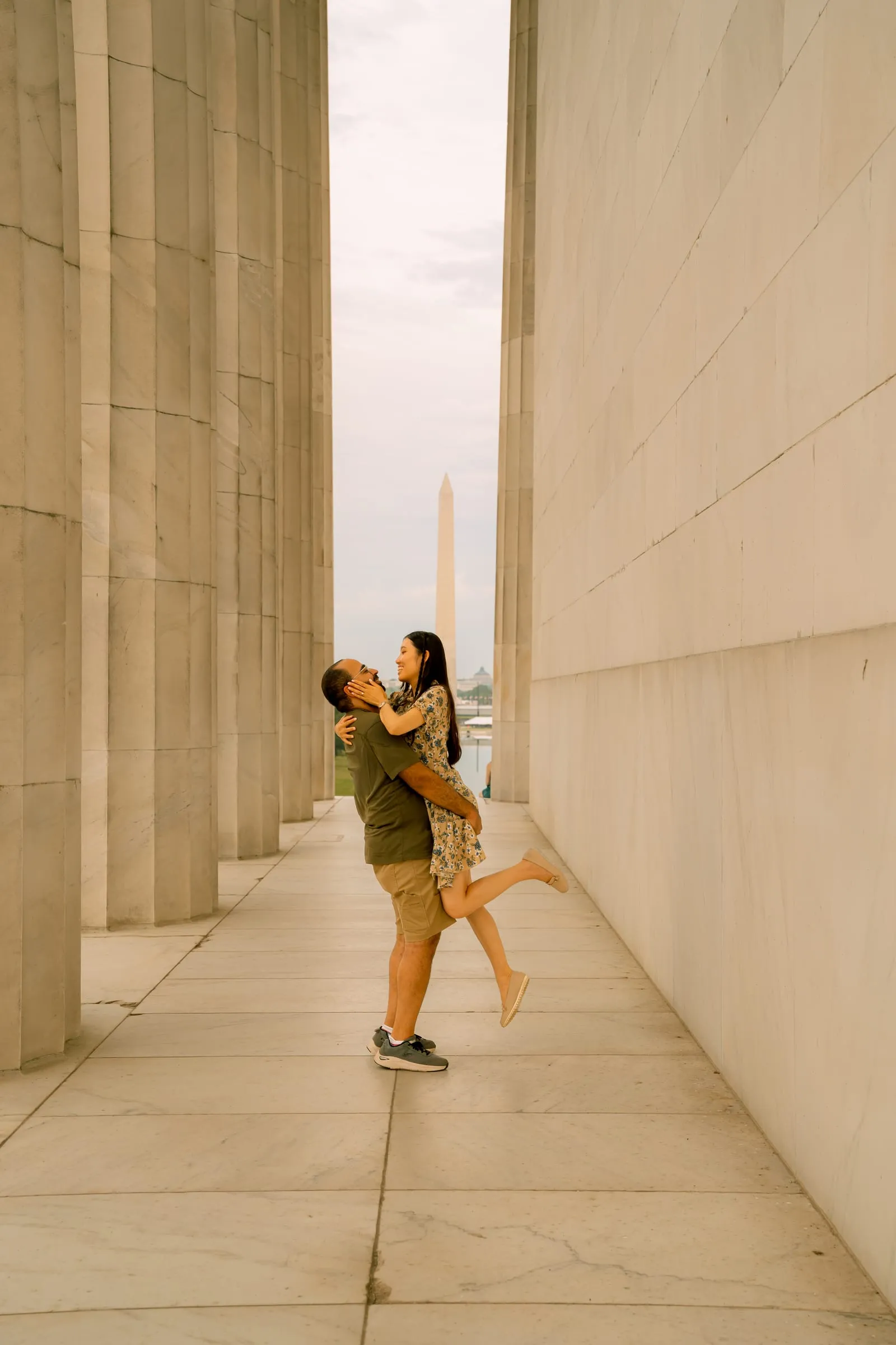Samuel lifting Maryann off the ground between the memorial's columns
