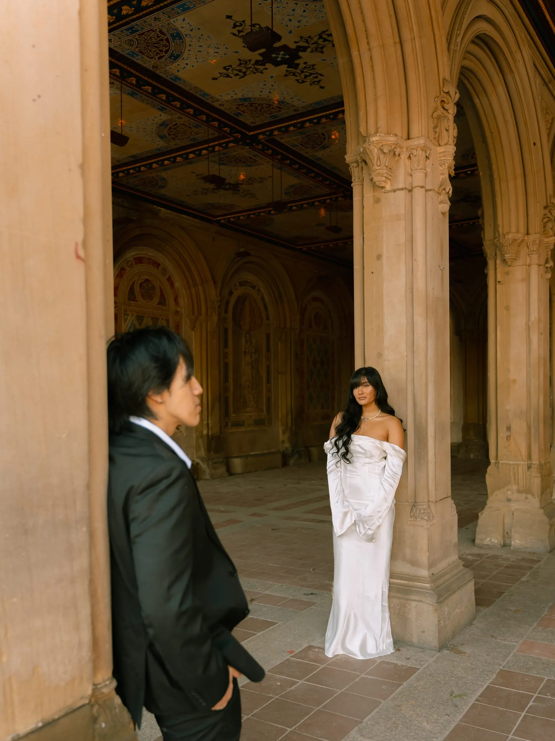 Noushin and Nathan gazing at each other across the Bethesda Terrace arcade