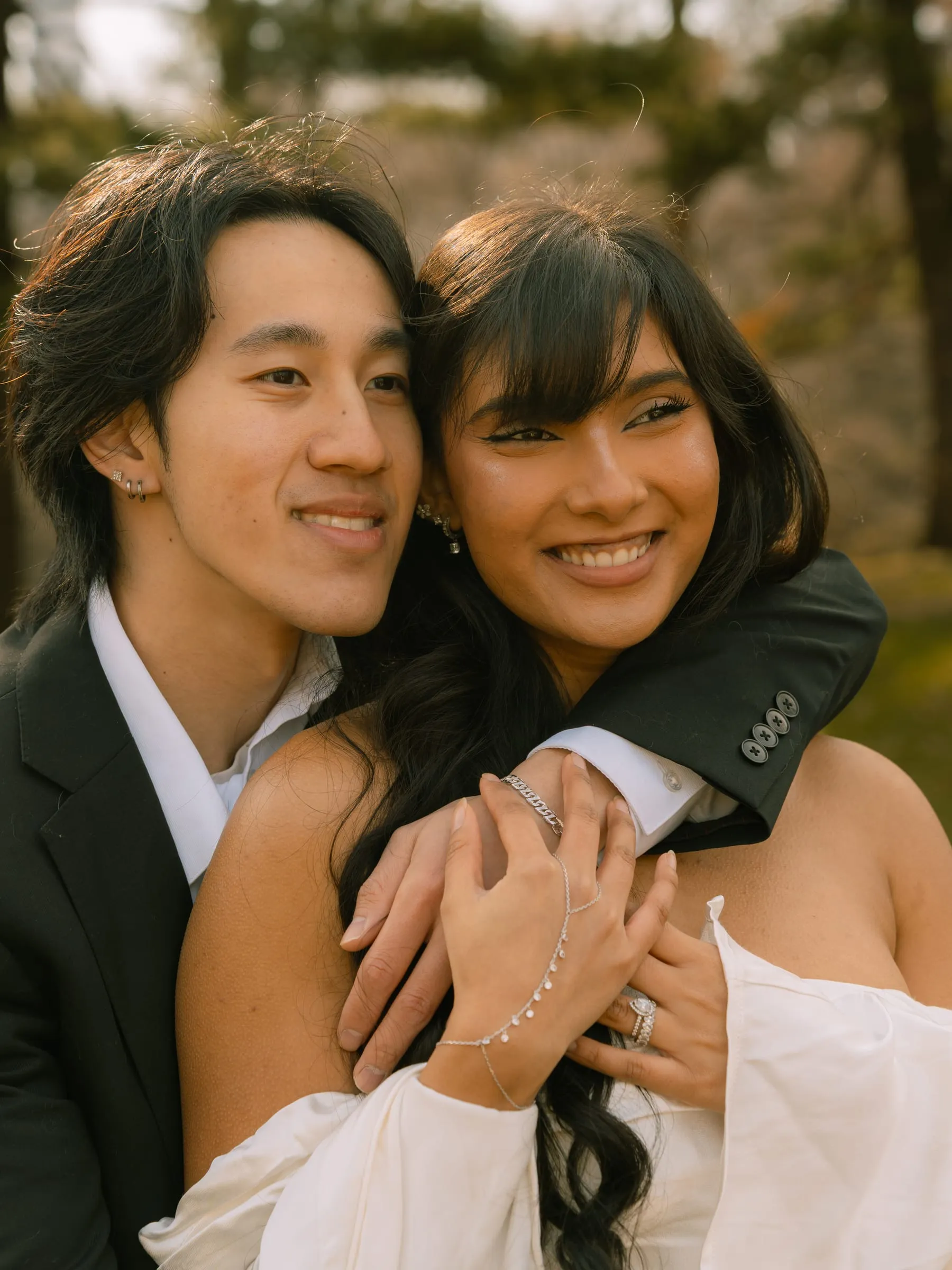 Noushin and Nathan laughing together in a close portrait