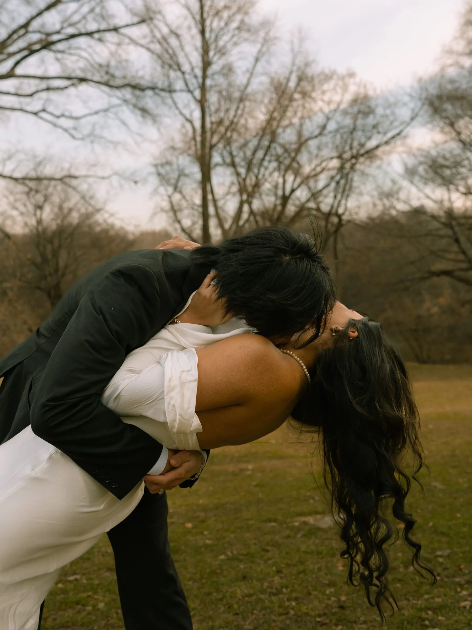 Nathan dipping Noushin for a kiss in the park as evening falls