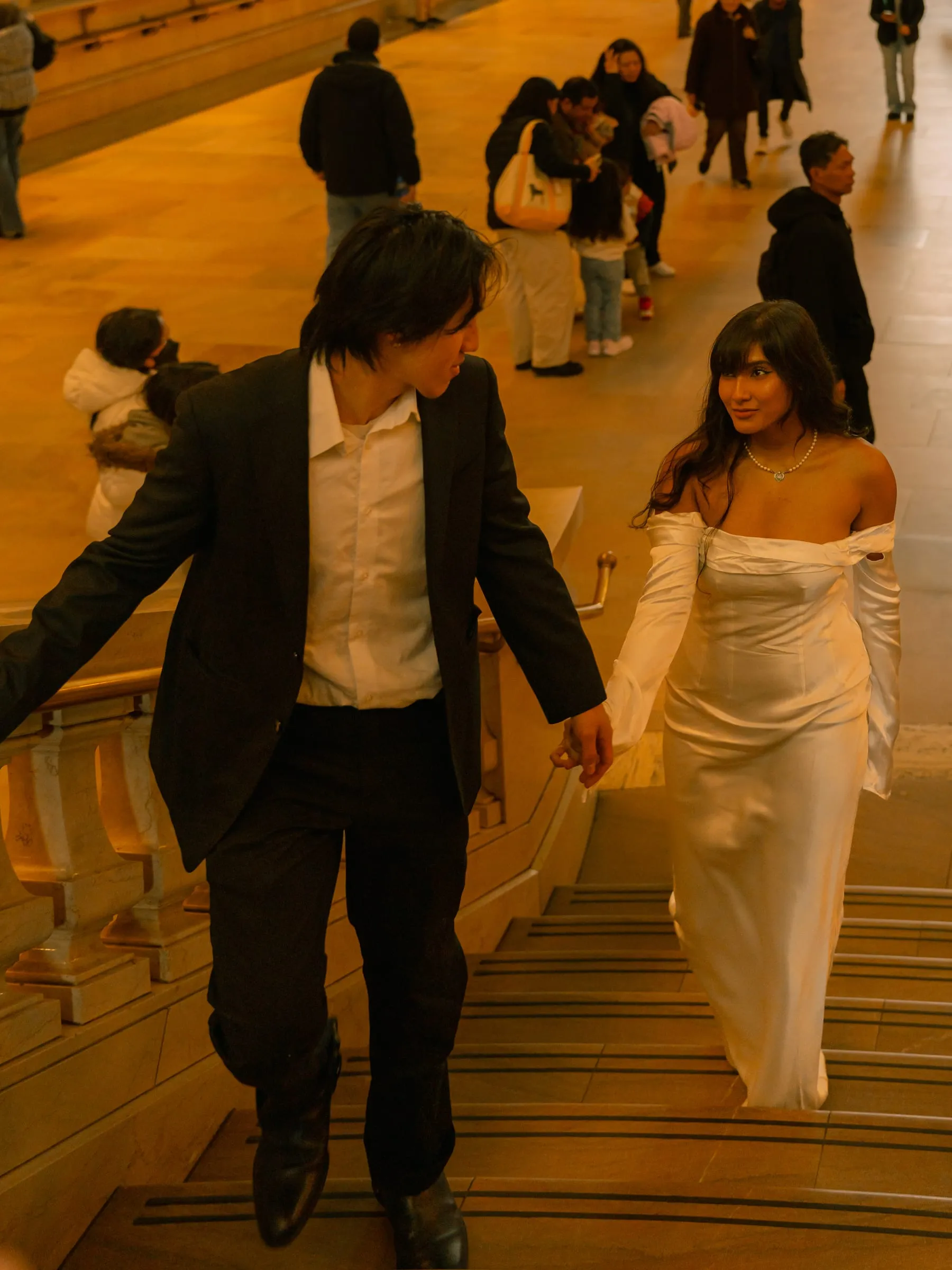Noushin and Nathan climbing the marble staircase at Grand Central Terminal