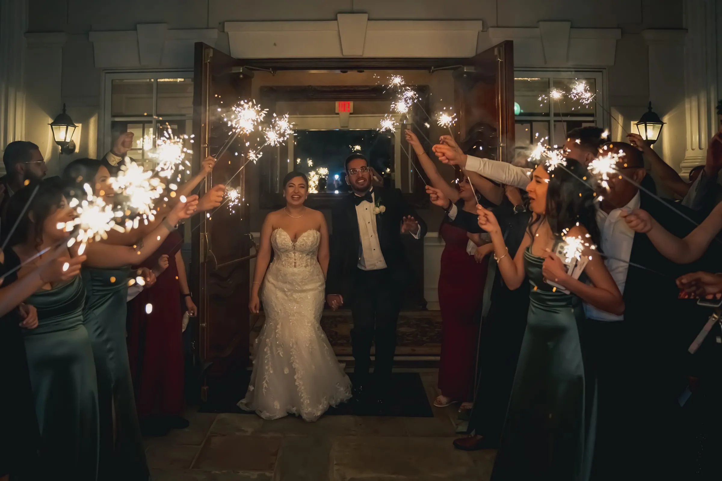 A wide view of the sparkler send-off at the entrance of Foxchase Manor