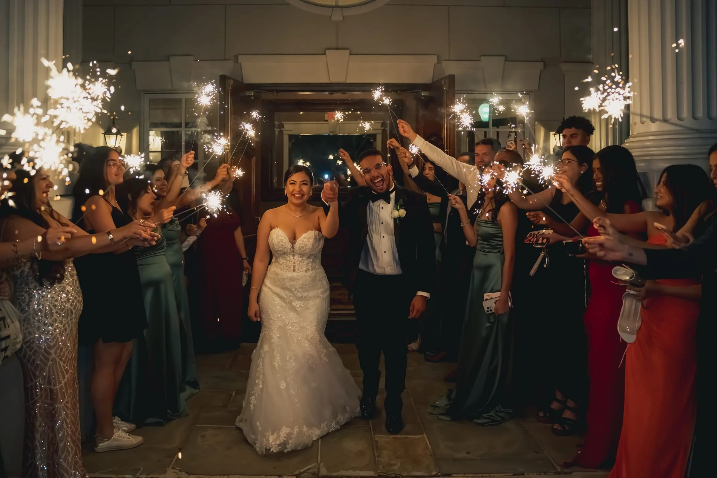 Sandy and Steph smiling at the camera in the middle of the sparkler exit