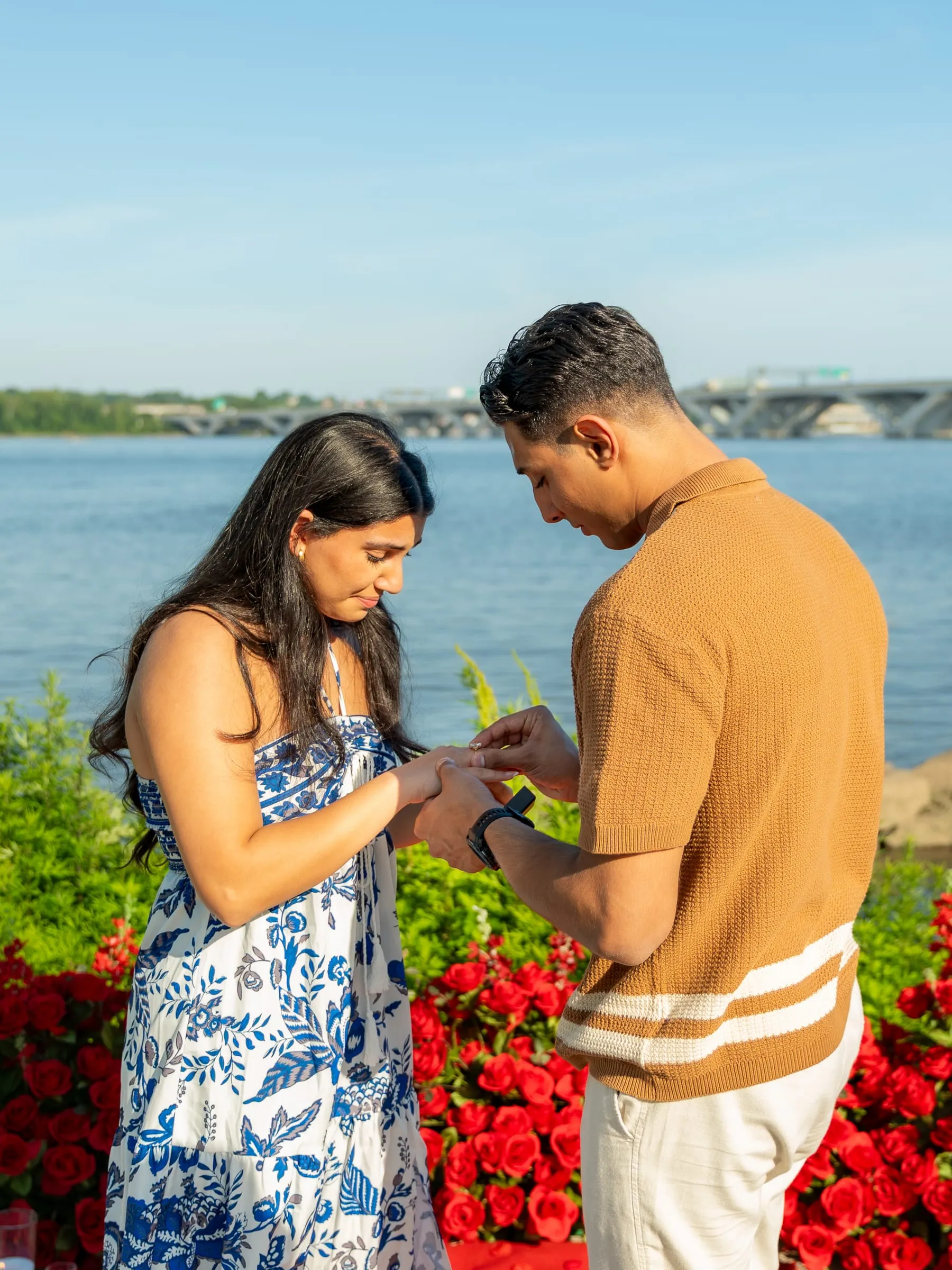 A close-up of Thomas sliding the engagement ring onto Verina's finger